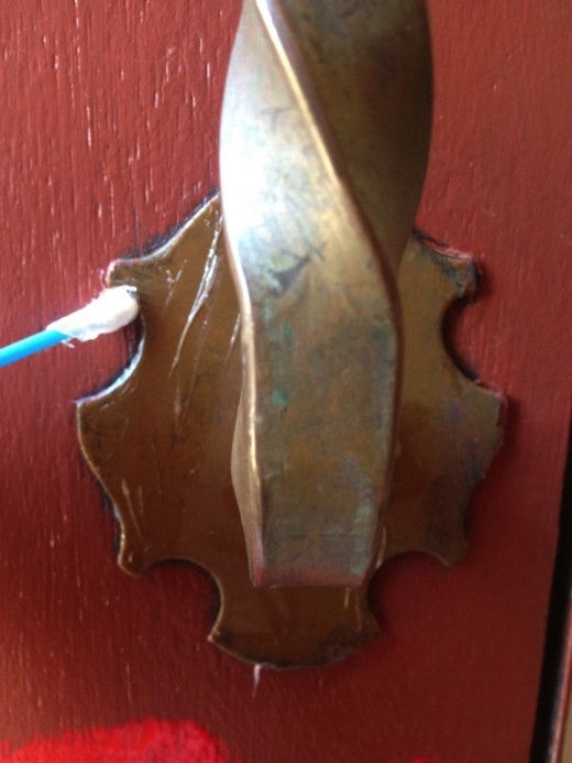 Putting petroleum jelly on door hardware
