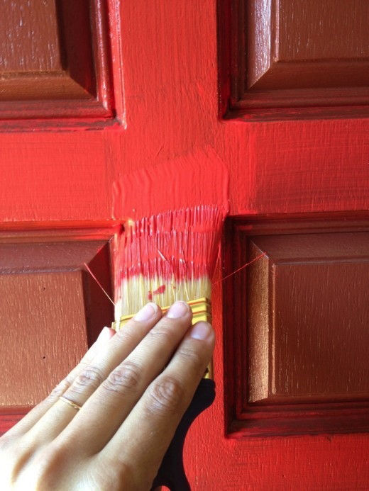 Painting front door with paint brush