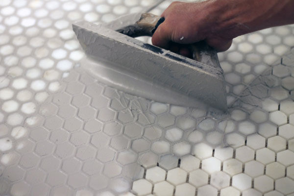 The process of grouting bathroom tile