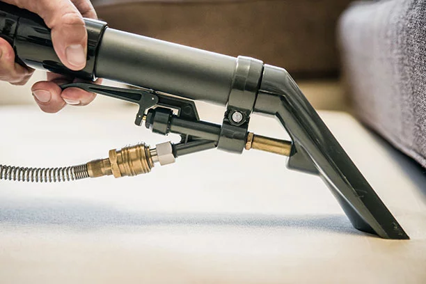 Close-up of a carpet cleaner actively being used to clean a carpet