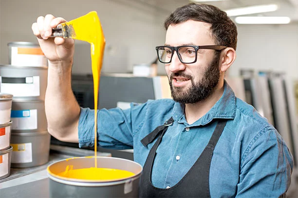 Man Mixing Yellow paint
