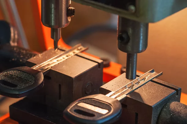 Key cutting machine cutting a car key