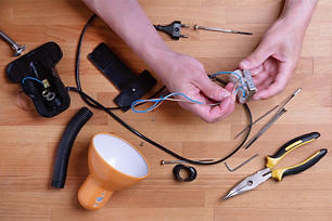 A person repairing a lamp