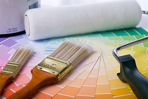Different color swatches laid out with paint brushes and a roller