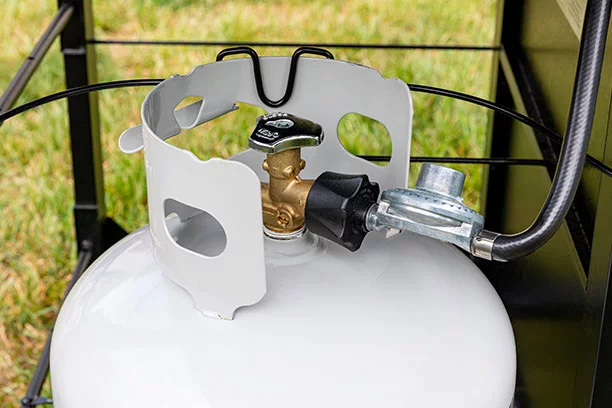 Propane tank with connection hose to a grill