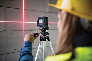 Woman using a laser level that she rented