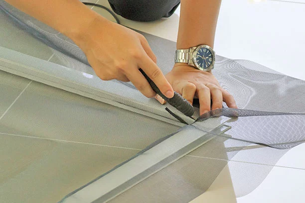  man install mosquito net wire screen on house window protection against insect