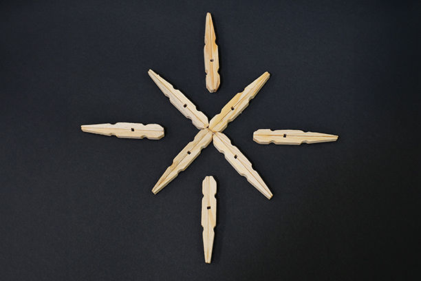 Clothespins laid out in the desired snowflake design