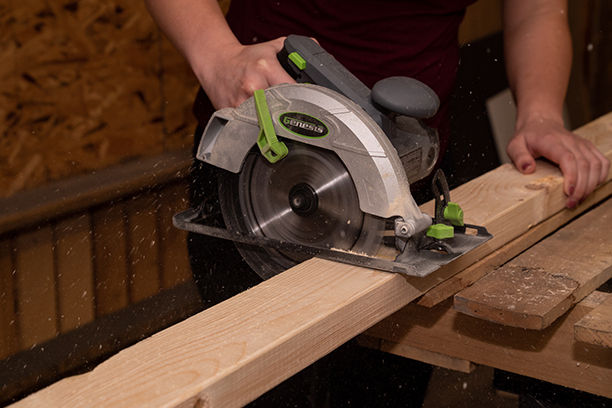 Person using a circular saw to cut wood