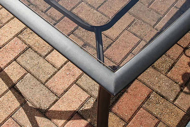 The corner of a glass patio table