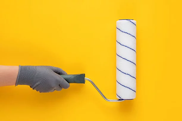 paint roller on yellow wall