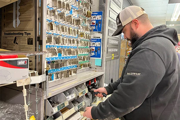 Employee cutting a key