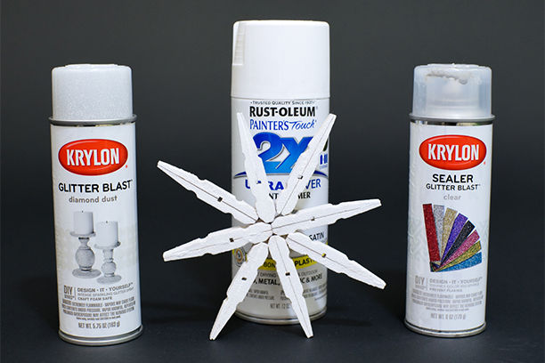 Krylon and Rust-Oleum spray paint with painted clothespin snowflake