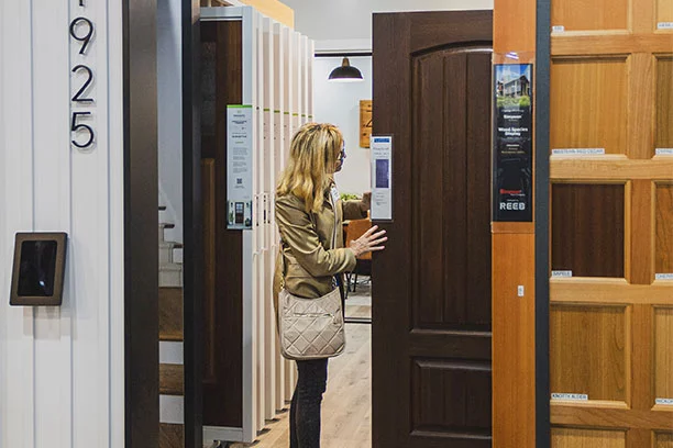 Woman looking at doors in a hardware store