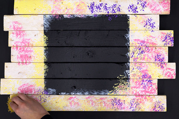 Using a sponge to apply different pastel colored paints