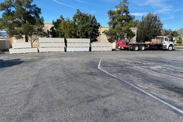 Stacked Lumber in the parking lot of Best Lumber & Hardware