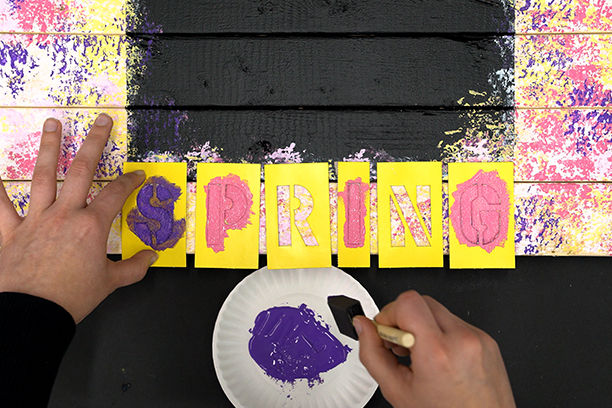 Stenciling on letters to spell out "Spring"