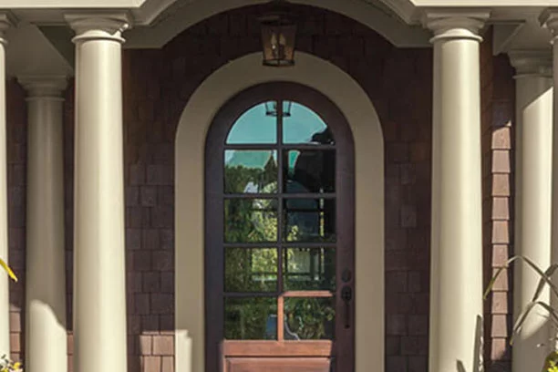 The front door of a brown and beige house