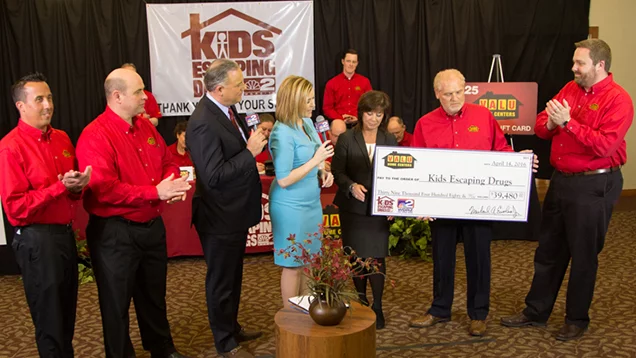Check presentation with representatives from Valu and Kids Escaping Drugs