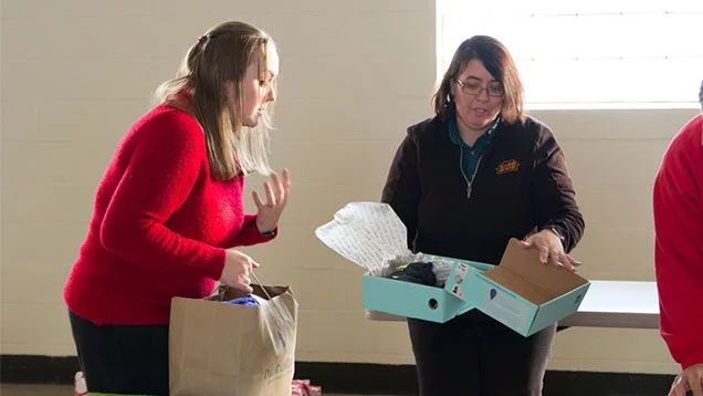 Valu team members organizing a boxing toys being donated