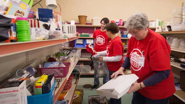 Valu Crew volunteers removing old merchandise, organizing shelves, clearing out damaged or broken goods