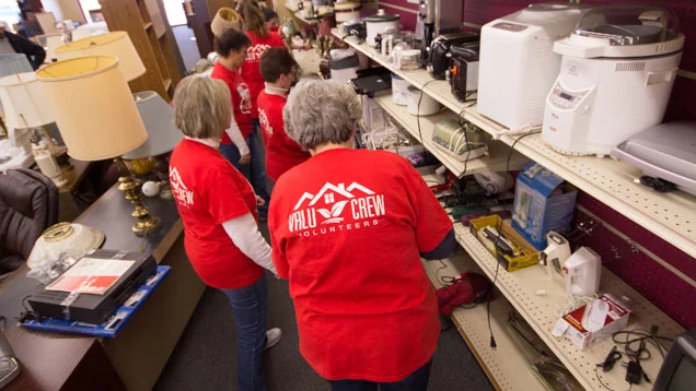 Valu Crew volunteers removing old merchandise, organizing shelves, clearing out damaged or broken goods