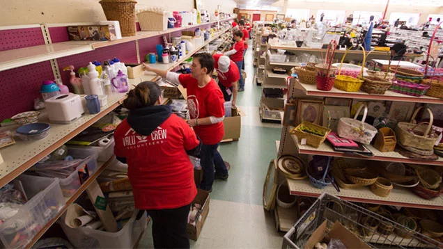 Valu Crew volunteers removing old merchandise, organizing shelves, clearing out damaged or broken goods