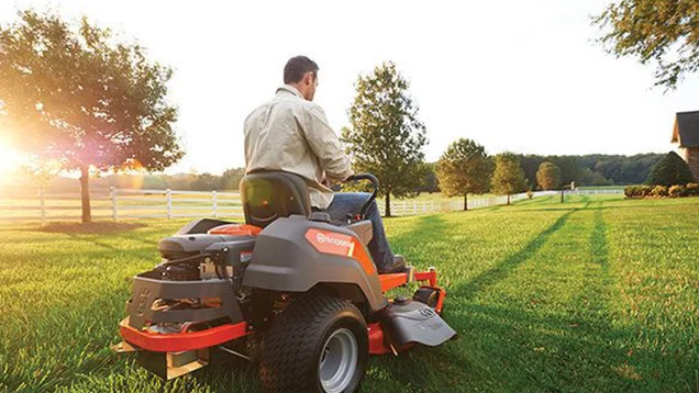 man mowing lawn on riding lawnmower