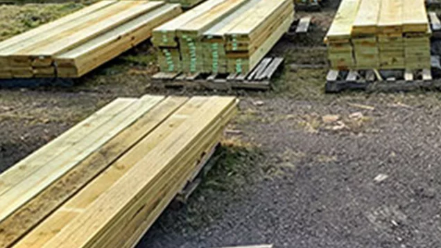 Piles of treated lumber stacked outside