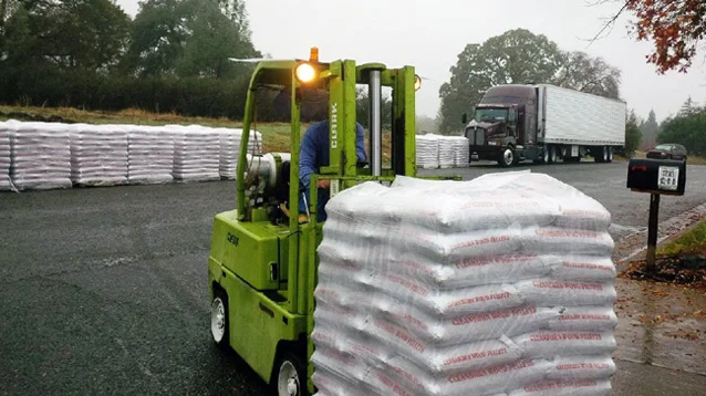 fork lift carrying wood pellet bags