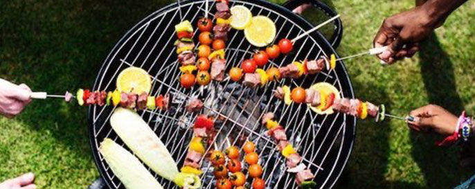 People Grilling Over a Grill