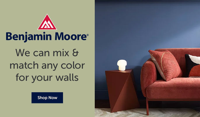 Text on the left,  "Benjamin Moore. We can mix and match any color for your walls"" - Image on the right, Dark blue painted living room wall with a red couch and side table against it.