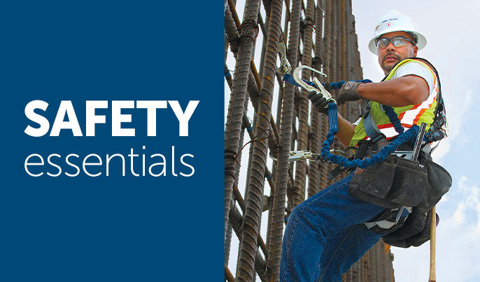Safety Essentials - Construction working wearing fall protection gear while working on a high rise 
