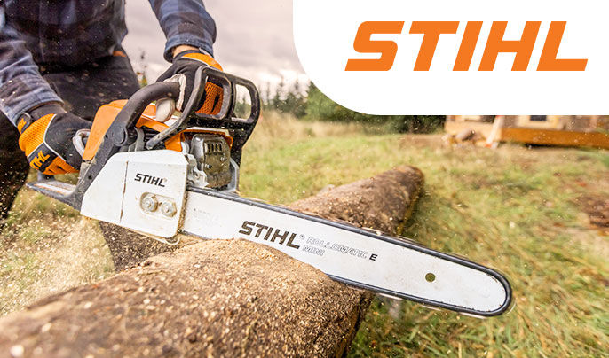 Stihl - Middle aged man using a STIHL gas powered chainsaw to cut down a tree