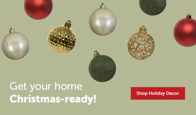 Text right - "Get your home Christmas-ready" Shop holiday decor button. Green, red, silver and gold ornaments spread on green background