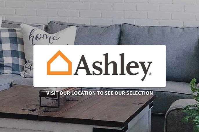 A couch in a living room with Ashley Furniture logo on top