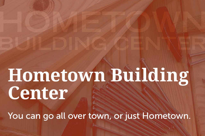 Text left, "Hometown Building Center. You can go all over town, or just hometown." Background image of plywood and nails.