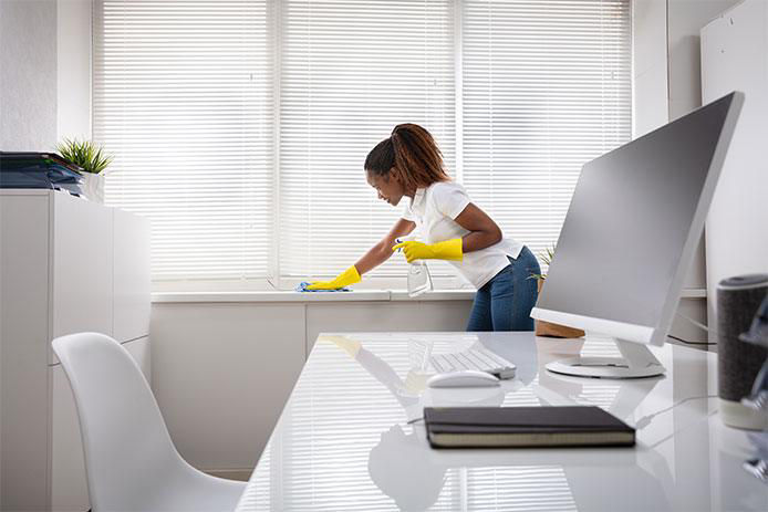 Woman cleaning around windows