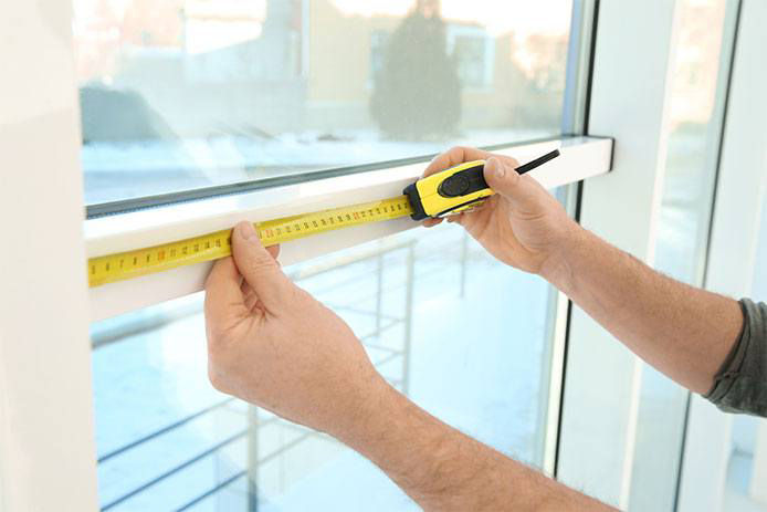 Measuring a window with a tape measure