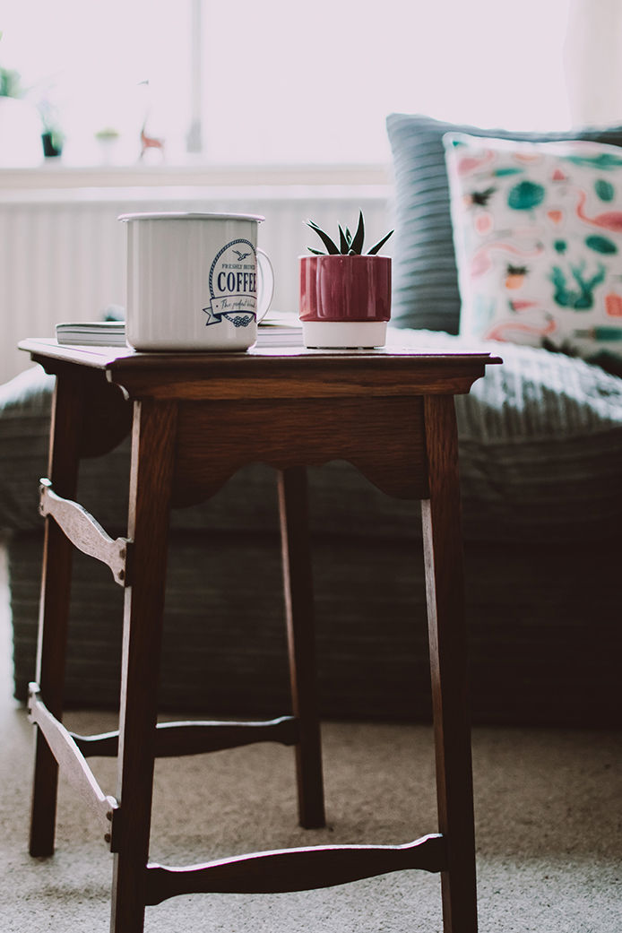 Coffe cup sitting on wood side table