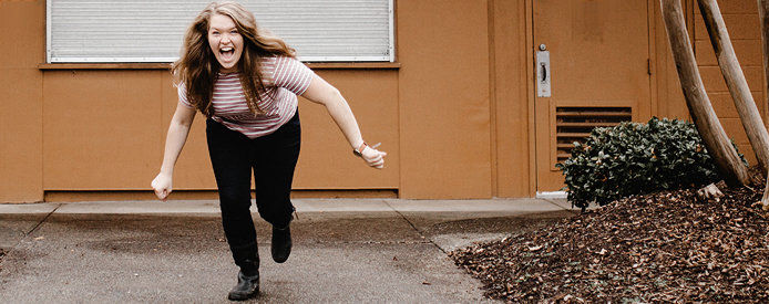 A woman running from a brown home