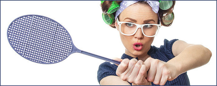 A woman in curlers holding a purple fly swatter tennis racket and wearing white glasses 