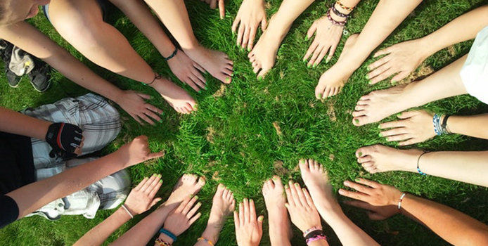 Circle of people in clean grass