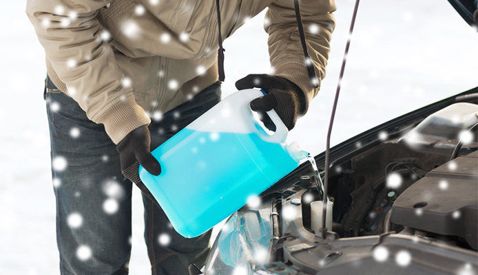 Pouring antifreeze in car