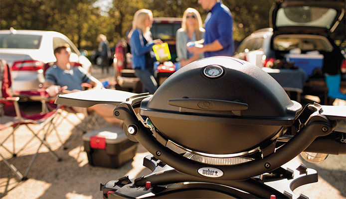 Featuring a Weber Q Series grill at a tailgating party