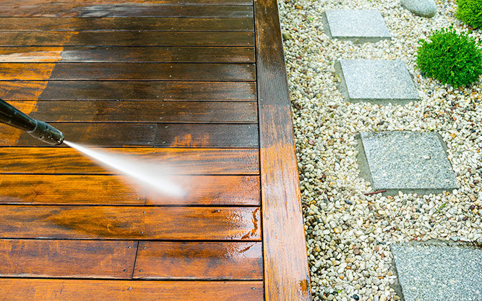 Power washing a wooden deck