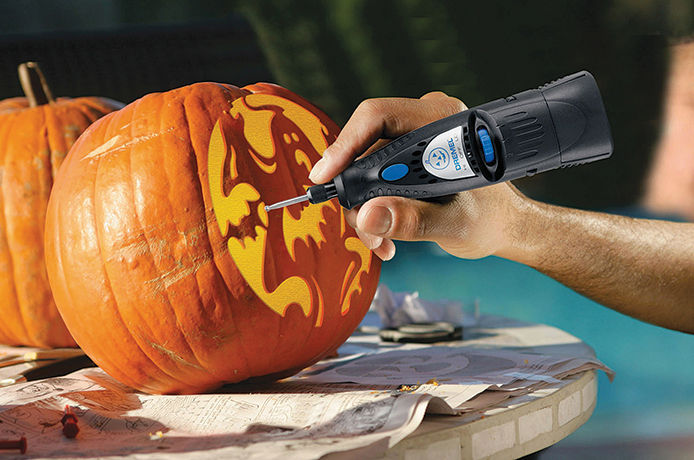 Dremel rotary tool being used to carve a pumpkin