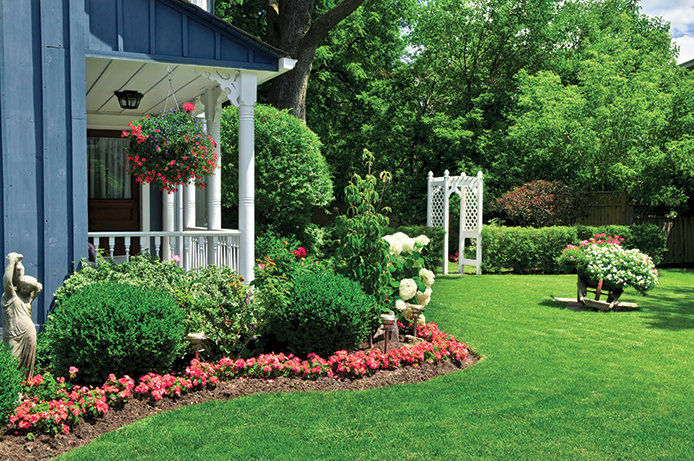 A yard decorated with flowers and greenery