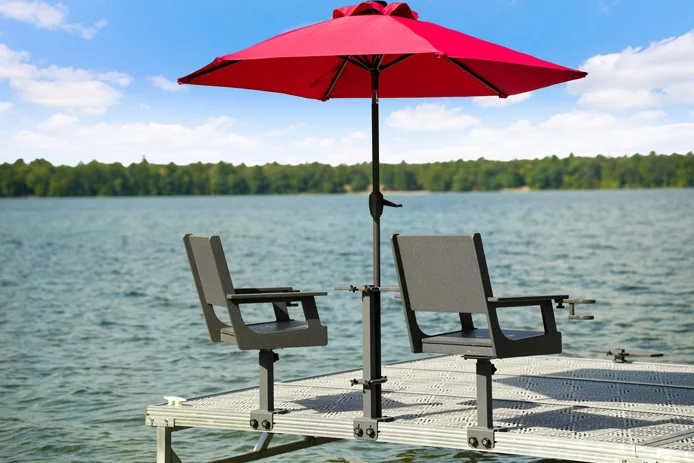 custom dock with chairs and umbrella on lake