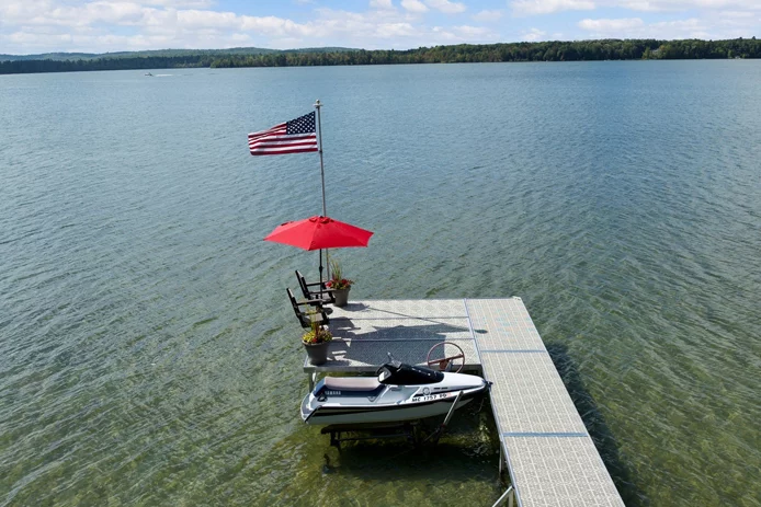 dock on lake with jetski and american flag